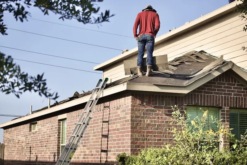 Professional roofer working on a residential roof in Palm Tree